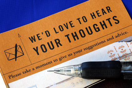 Customer fills in the feedback survey isolated on blue Customer fills in the feedback survey isolated on blue